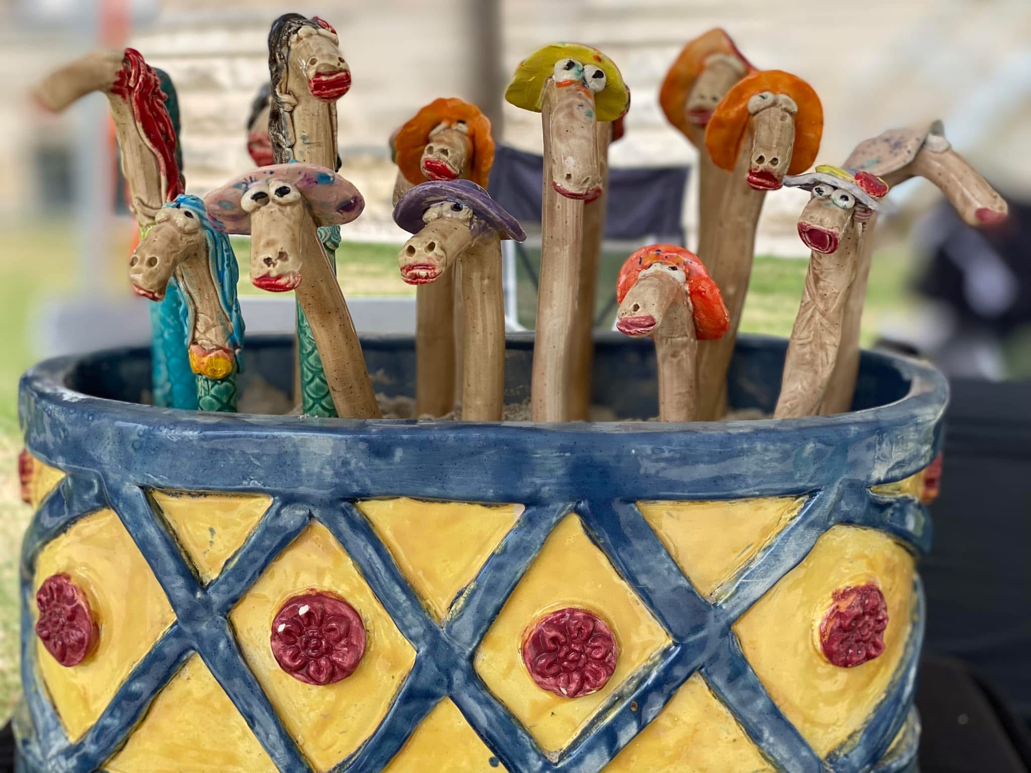 Blue and yellow planter with whimsical ceramic characters